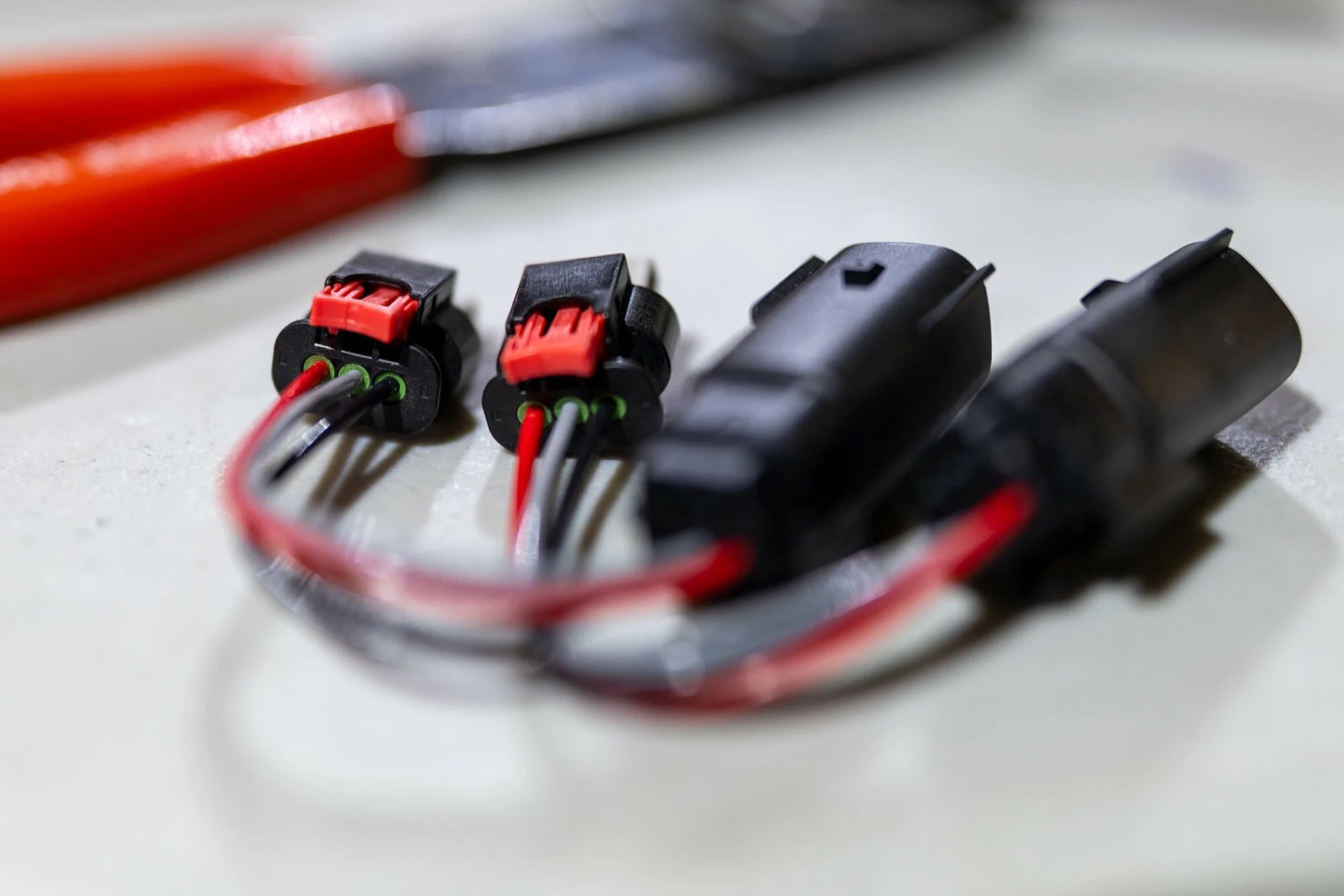 A matched pair of Matrix headlight adapters, three-pin end and car-side end